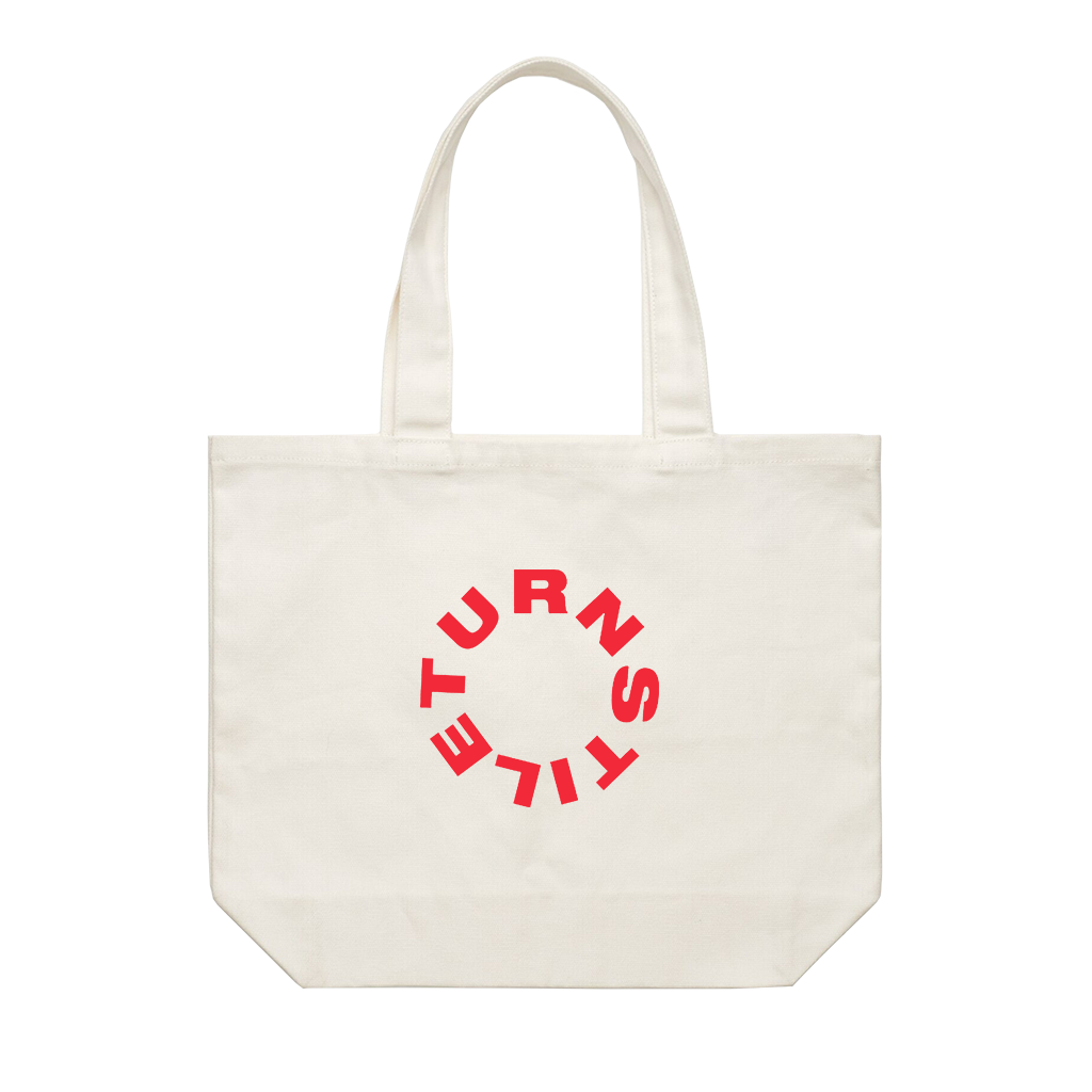 Turnstile's "Flip" design, printed on the front and back of a natural canvas tote bag. Tote features: Reinforced should straps; one large main compartment; Mid weight, 9.4 oz/yd2; 100% cotton canvas.